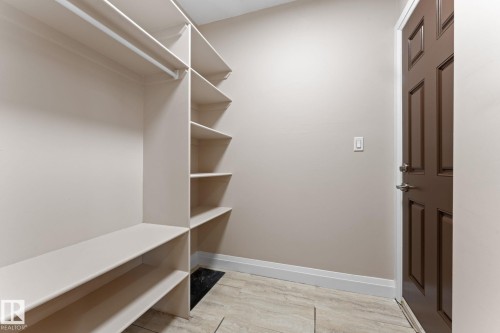 Entryway with built-in shelving, hanging rod, and bench seating - 16543 132 Street, Edmonton, AB - Indoor With Storage