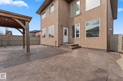 Expansive stamped concrete patio with a detached wooden gazebo - 