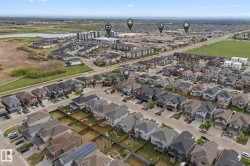 Aerial perspective showcasing a residential development with multiple single-family homes and townhomes - 
