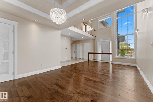 Vaulted ceilings featuring a tiered chandelier and recessed lighting - 16543 132 Street, Edmonton, AB - Indoor Photo Showing Other Room