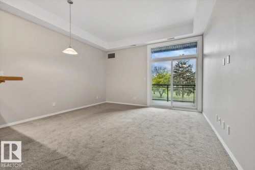Spacious room with plush carpeting and light-toned walls - 228 10531 117 Street, Edmonton, AB - Indoor Photo Showing Other Room