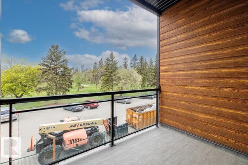 Private balcony featuring a glass railing system and durable tile flooring - 228 10531 117 Street, Edmonton, AB - Outdoor With Exterior