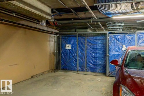 Assigned parking space with concrete flooring - 228 10531 117 Street, Edmonton, AB - Indoor Photo Showing Garage
