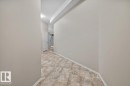 Interior hallway featuring neutral wall tones and patterned tile flooring - 228 10531 117 Street, Edmonton, AB  - Indoor Photo Showing Other Room 