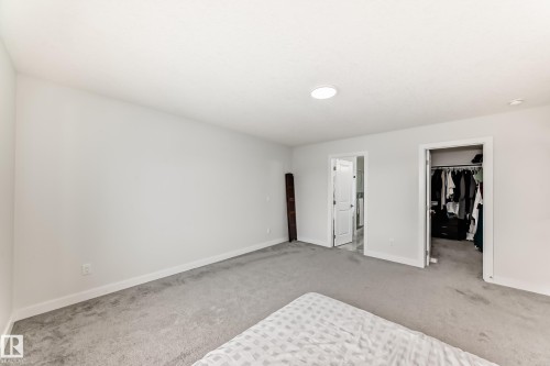 Spacious room featuring light gray carpeting, crisp white walls, and a recessed ceiling light - 4509 170A Avenue, Edmonton, AB - Indoor