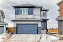 The property features a two-story exterior with light-colored siding and dark blue accents - 4509 170A Avenue, Edmonton, AB  - Outdoor 