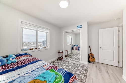 The room features light-colored walls and light wood-style flooring, creating a bright and airy atmosphere - 4509 170A Avenue, Edmonton, AB - Indoor Photo Showing Bedroom