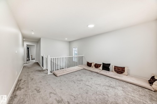 Well-lit open space featuring light-colored walls, recessed lighting, and grey carpeting - 4509 170A Avenue, Edmonton, AB - Indoor Photo Showing Other Room