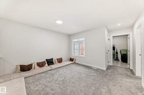 This versatile room features light gray carpeting, a window with white trim, and a white ceiling with recessed lighting - 4509 170A Avenue, Edmonton, AB - Indoor Photo Showing Other Room