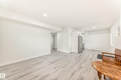 This property features light-colored flooring throughout, white walls, and recessed lighting - 4509 170A Avenue, Edmonton, AB - Indoor