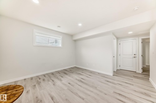 This room features light-colored flooring, a window, and recessed lighting - 4509 170A Avenue, Edmonton, AB - Indoor Photo Showing Other Room