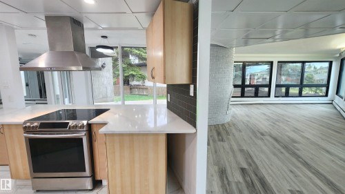 Contemporary kitchen featuring light wood cabinetry and white countertops - 9535 147 Avenue, Edmonton, AB - Indoor Photo Showing Other Room