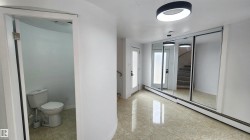 Entryway featuring tile flooring, sliding mirror wardrobe doors, and a contemporary ceiling fixture - 