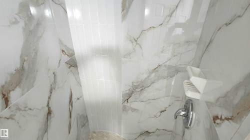 Shower stall featuring large format white tiled walls with brown veining and a contrasting vertical band of white subway tile - 9535 147 Avenue, Edmonton, AB - Indoor Photo Showing Bathroom