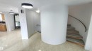 Spiral staircase with wood-finish treads and a curved metal handrail - 9535 147 Avenue, Edmonton, AB  - Indoor Photo Showing Other Room 