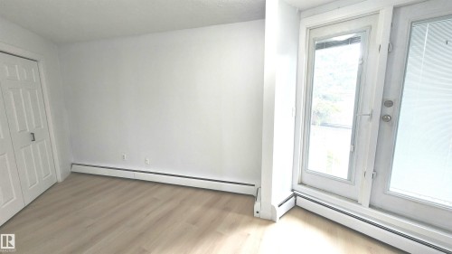 Room featuring light wood-finish flooring and white walls - 9535 147 Avenue, Edmonton, AB - Indoor Photo Showing Other Room