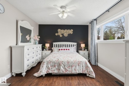 Bedroom featuring wood-finish flooring and a ceiling fan - 15232 120 Nw, Edmonton, AB 