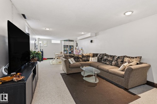 Spacious lower level featuring light-colored carpeting, recessed lighting, and a dark baseboard trim - 15232 120 Nw, Edmonton, AB 