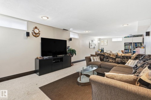 Finished lower level featuring recessed lighting, light-toned carpeting, and multiple egress windows - 15232 120 Nw, Edmonton, AB 