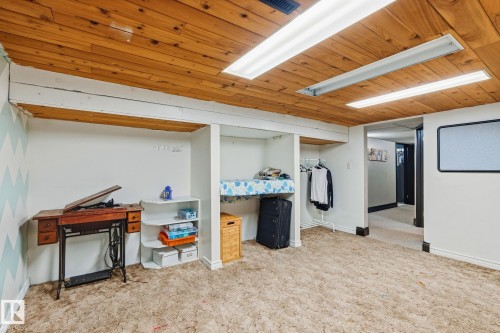 Wood-paneled ceiling with integrated fluorescent lighting, providing bright illumination - 15232 120 Nw, Edmonton, AB 