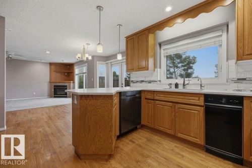 10 Coloniale Court, Beaumont, AB - Indoor Photo Showing Kitchen With Fireplace
