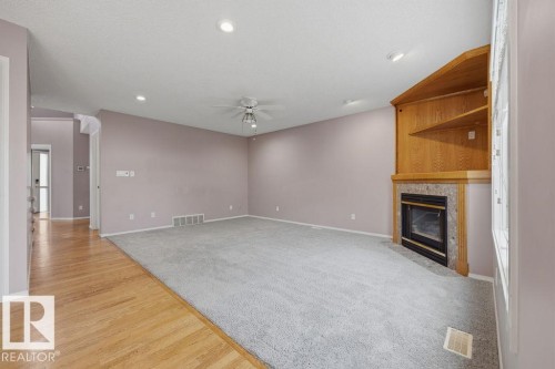 10 Coloniale Court, Beaumont, AB - Indoor Photo Showing Other Room With Fireplace