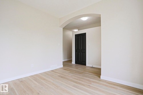 Bright interior space featuring light-toned wood-finish flooring and crisp white baseboards - 82 Meadowview Point(E), Sherwood Park, AB - Indoor Photo Showing Other Room