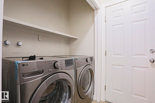 Dedicated laundry space featuring a white wall shelf - 82 Meadowview Point(E), Sherwood Park, AB - Indoor Photo Showing Laundry Room