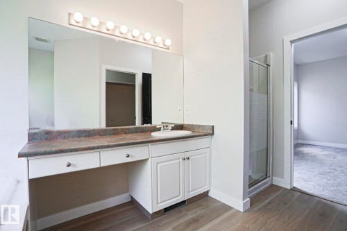 Bathroom vanity featuring a single sink, built-in makeup area, and overhead lighting - 82 Meadowview Point(E), Sherwood Park, AB - Indoor Photo Showing Bathroom