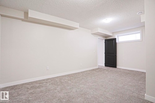 Carpeted room featuring light neutral wall paint and white trim - 82 Meadowview Point(E), Sherwood Park, AB - Indoor Photo Showing Other Room