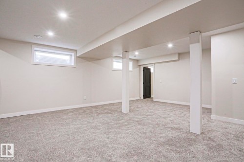 Spacious room featuring light grey carpeting, recessed lighting, and neutral wall paint - 82 Meadowview Point(E), Sherwood Park, AB - Indoor Photo Showing Basement
