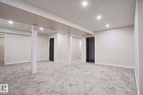Spacious lower-level room featuring light gray carpet, recessed lighting, and crisp white trim - 82 Meadowview Point(E), Sherwood Park, AB - Indoor Photo Showing Basement