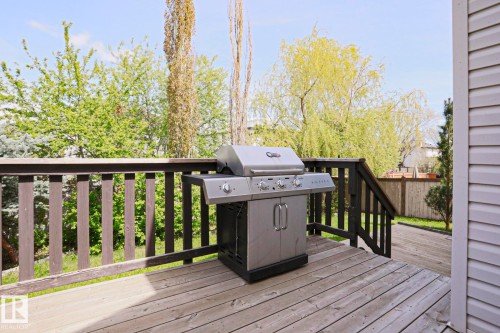 Spacious wood deck with dark-stained railings and steps, featuring exterior siding - 82 Meadowview Point(E), Sherwood Park, AB - Outdoor With Exterior