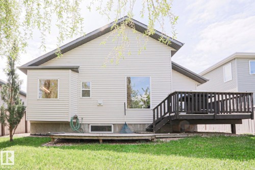 Rear exterior featuring light-colored siding and a dark-stained elevated deck - 82 Meadowview Point(E), Sherwood Park, AB - Outdoor With Deck Patio Veranda With Exterior