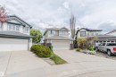 Front exterior showcasing a two-story residence with light-toned siding, an attached garage, and a concrete driveway - 3534 Mclean Crescent, Edmonton, AB  - Outdoor With Facade 