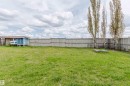Expansive green lawn with a solid wood fence - 3534 Mclean Crescent, Edmonton, AB  - Outdoor 