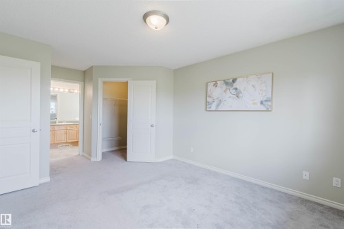 Carpeted room with light-toned walls, a flush-mount ceiling light, and white trim - 3534 Mclean Crescent, Edmonton, AB - Indoor Photo Showing Other Room