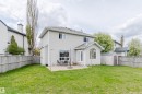 Expansive green lawn featuring a concrete patio, a bay window, and a storage shed - 3534 Mclean Crescent, Edmonton, AB  - Outdoor 