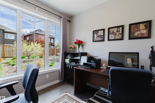 Bright room featuring large windows, wood-finish flooring, and light-toned wall paint - 3571 Keswick Boulevard, Edmonton, AB - Indoor Photo Showing Office