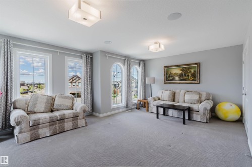 Spacious room featuring light gray walls and plush gray carpeting - 3571 Keswick Boulevard, Edmonton, AB - Indoor Photo Showing Living Room