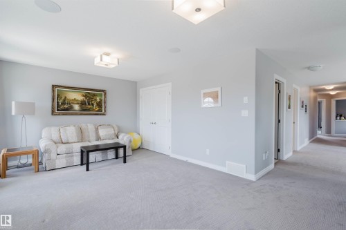 Spacious carpeted room featuring light gray walls, white trim, and recessed ceiling lighting - 3571 Keswick Boulevard, Edmonton, AB - Indoor