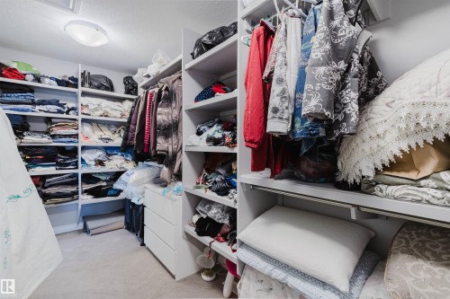 Custom closet system featuring extensive shelving and hanging rods - 3571 Keswick Boulevard, Edmonton, AB - Indoor With Storage