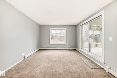 This room features light grey walls and carpeted flooring - 101 530 Watt Boulevard, Edmonton, AB - Indoor Photo Showing Other Room