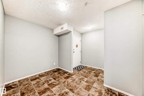 Entryway featuring tiled flooring, light gray walls, and a ceiling light fixture - 101 530 Watt Boulevard, Edmonton, AB - Indoor Photo Showing Other Room