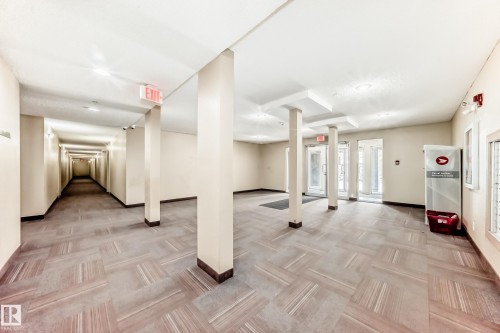 Spacious common area with patterned flooring, white walls, and recessed lighting - 101 530 Watt Boulevard, Edmonton, AB - Indoor Photo Showing Other Room