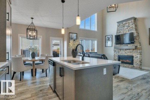 777 Berg Loop, Leduc, AB - Indoor Photo Showing Kitchen With Fireplace With Double Sink