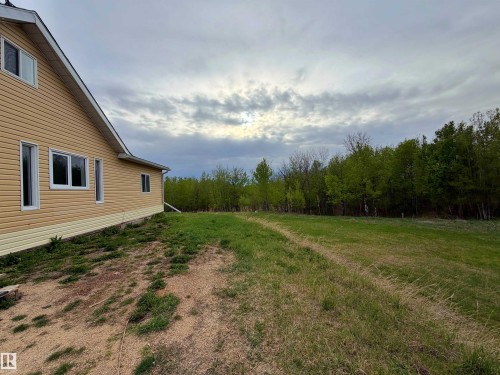 Exterior featuring horizontal siding, white trim, and a sloped roofline - 60016 Rr 41, Rural Barrhead County, AB - Outdoor