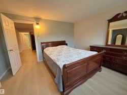 Light wood-finish flooring throughout the room and hallway - 