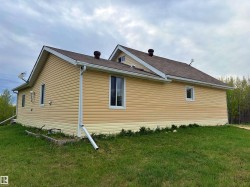 Exterior siding in a two-tone finish, featuring horizontal panels on the upper section and a contrasting lower band - 