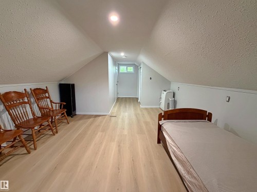 Open room featuring light wood-finish flooring, white walls, and a sloped ceiling with recessed lighting - 60016 Rr 41, Rural Barrhead County, AB - Indoor Photo Showing Other Room